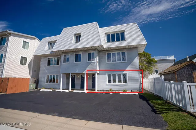 a front view of a residential apartment building with a yard