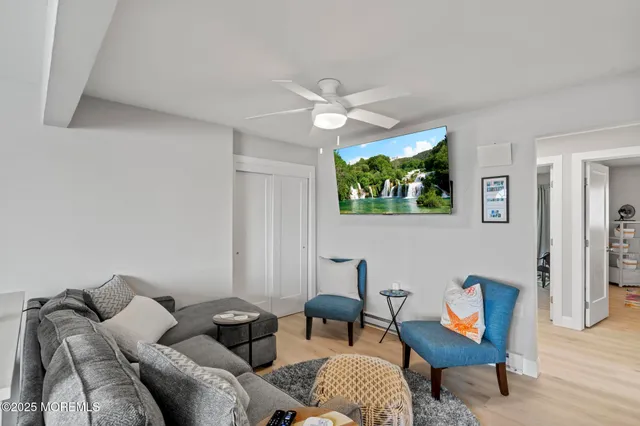 a living room with furniture a rug and a window