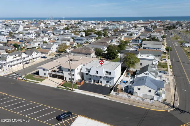 an aerial view of residential houses with city view