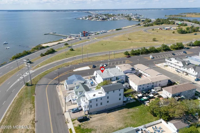 a view of swimming pool with outdoor seating and ocean view
