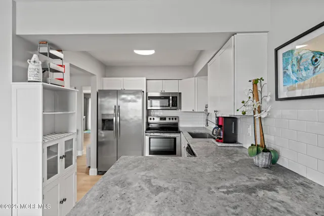 a kitchen with refrigerator and microwave