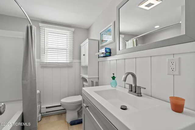 a bathroom with a sink toilet and a mirror