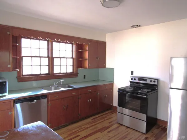 a kitchen with granite countertop a stove and a sink