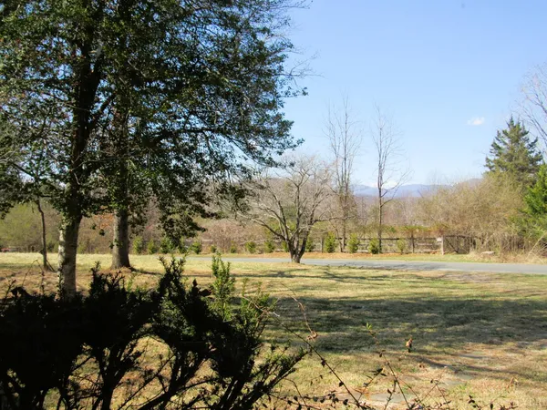 a view of a room with wooden floor and a window