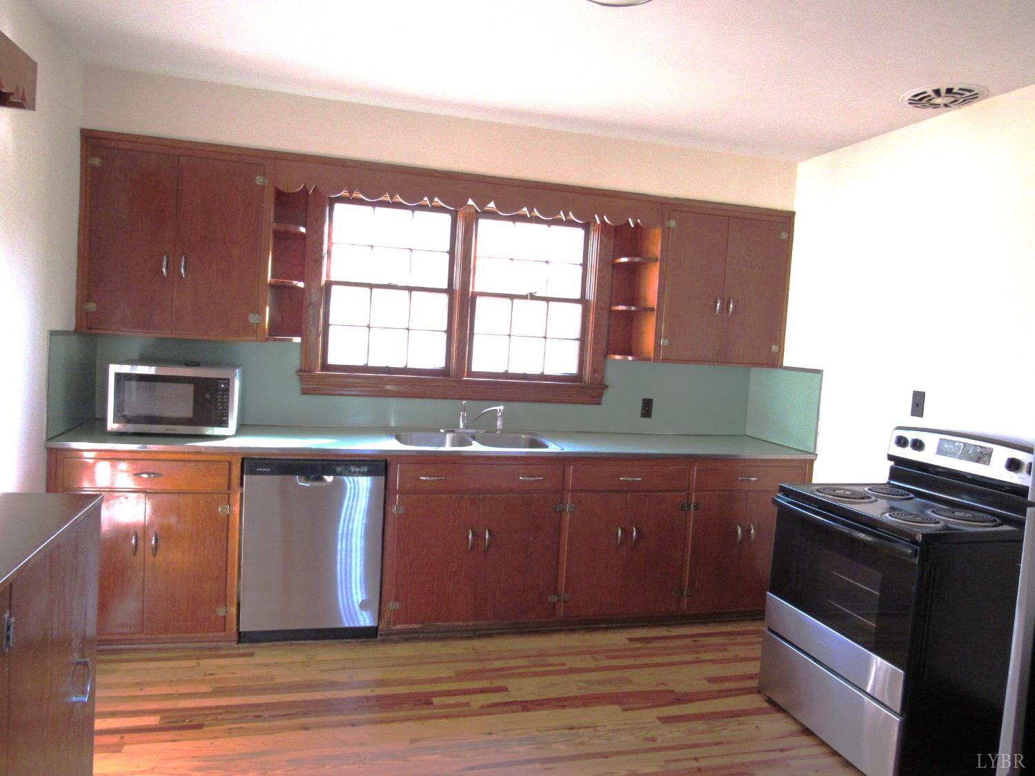 328 Huff Creek Trail Amherst, VA 24521 - Photo 12 of 41 a kitchen with stainless steel appliances granite countertop a stove a sink and a microwave