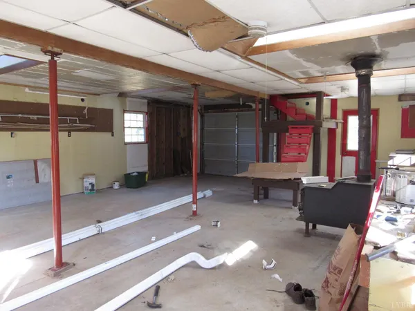 an empty room with wooden floor closet and windows
