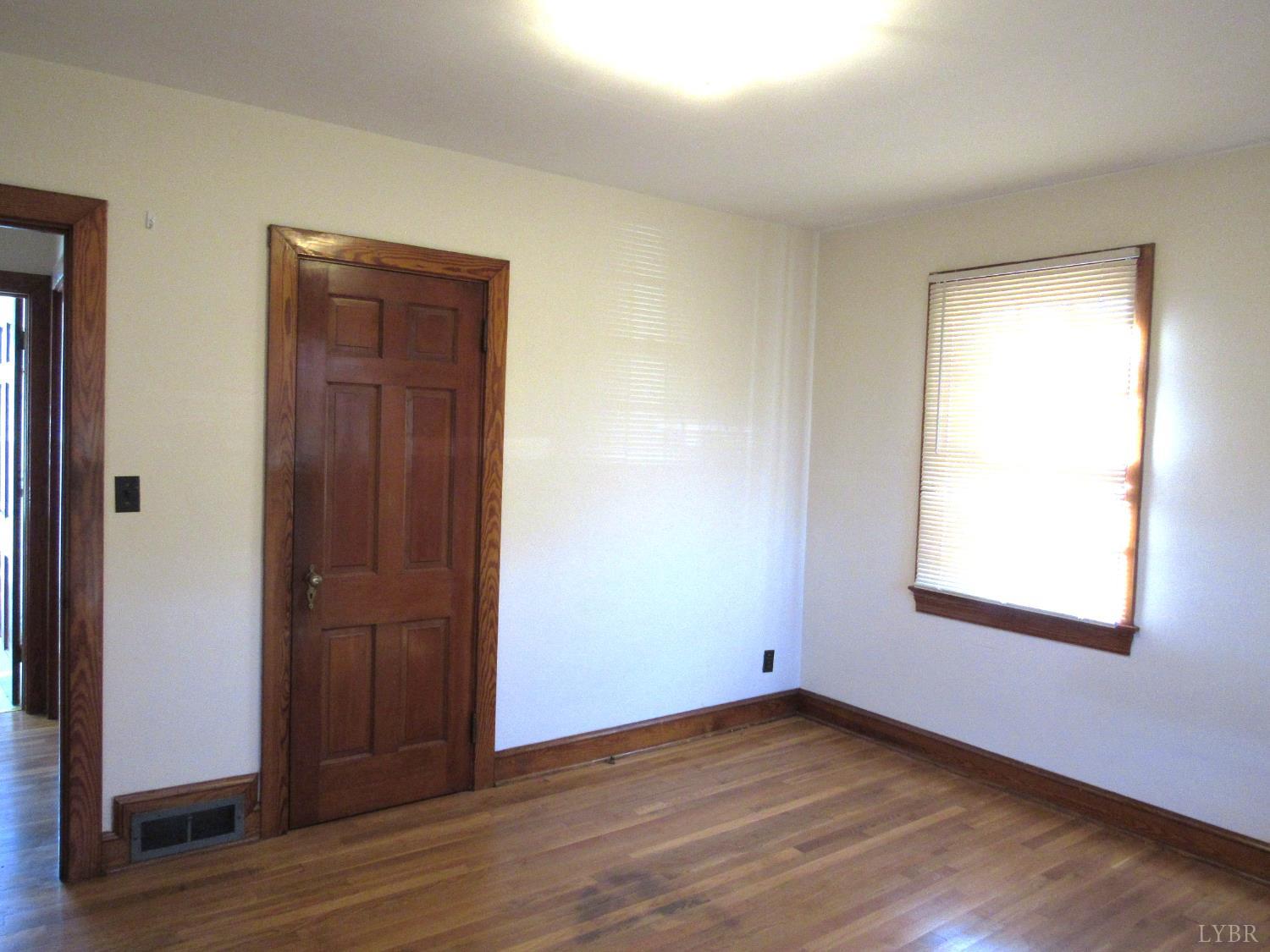 328 Huff Creek Trail Amherst, VA 24521 - Photo 20 of 41 an empty room with wooden floor closet and windows