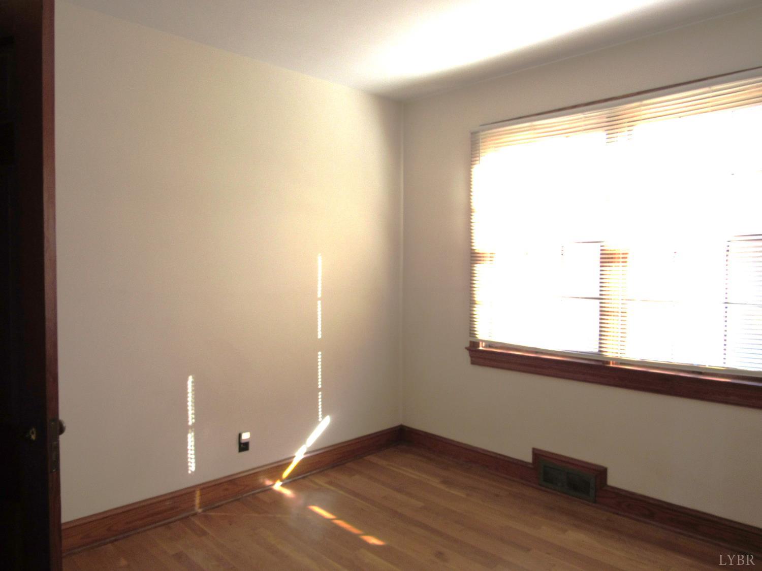 328 Huff Creek Trail Amherst, VA 24521 - Photo 21 of 41 a view of an empty room with wooden floor and a window