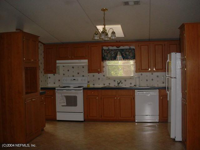 1561 Blair Road South Jacksonville, FL 32221 - Photo 2 of 5 a kitchen with stainless steel appliances granite countertop a stove a sink and a refrigerator