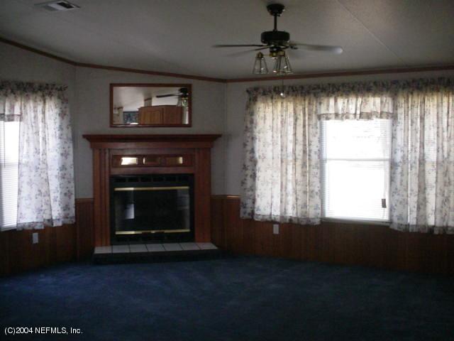 1561 Blair Road South Jacksonville, FL 32221 - Photo 3 of 5 a living room with a fireplace and windows