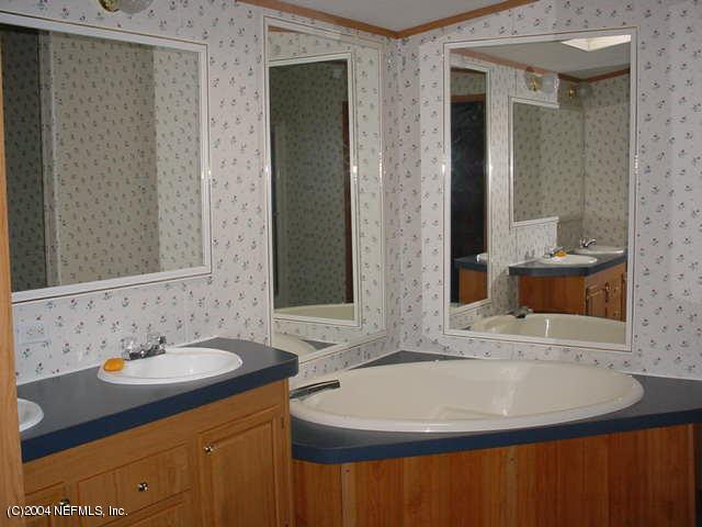1561 Blair Road South Jacksonville, FL 32221 - Photo 4 of 5 a bathroom with a sink and a mirror