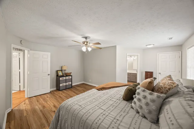 a bedroom with a large bed and a chandelier