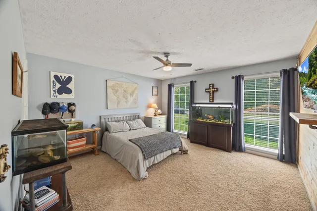 a bedroom with a bed and glass door