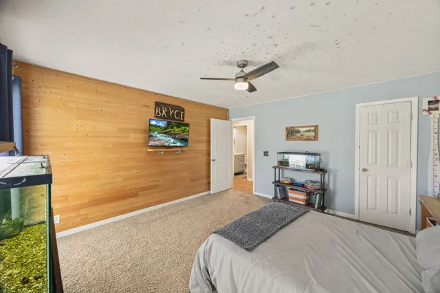 a bedroom with a bed work place view and a window