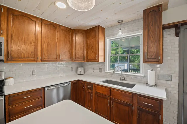 a kitchen with a sink cabinets and window