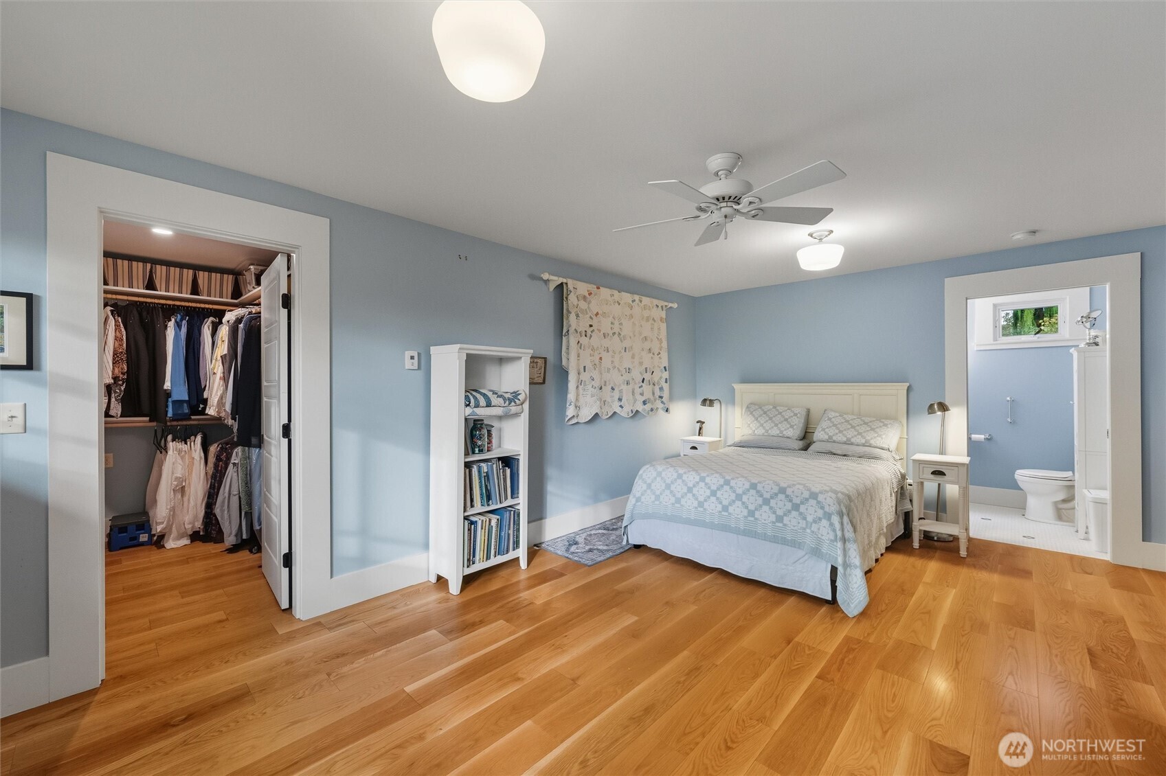 1131 16th Street Bellingham, WA 98225 - Photo 18 of 40 a spacious bedroom with a bed and a chandelier
