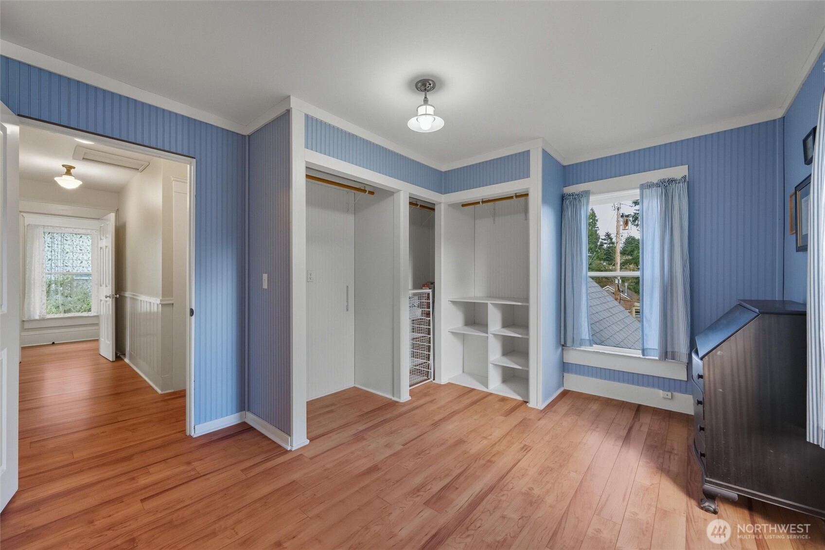 1131 16th Street Bellingham, WA 98225 - Photo 28 of 40 a view of a livingroom with wooden floor and a kitchen space with a flat screen tv