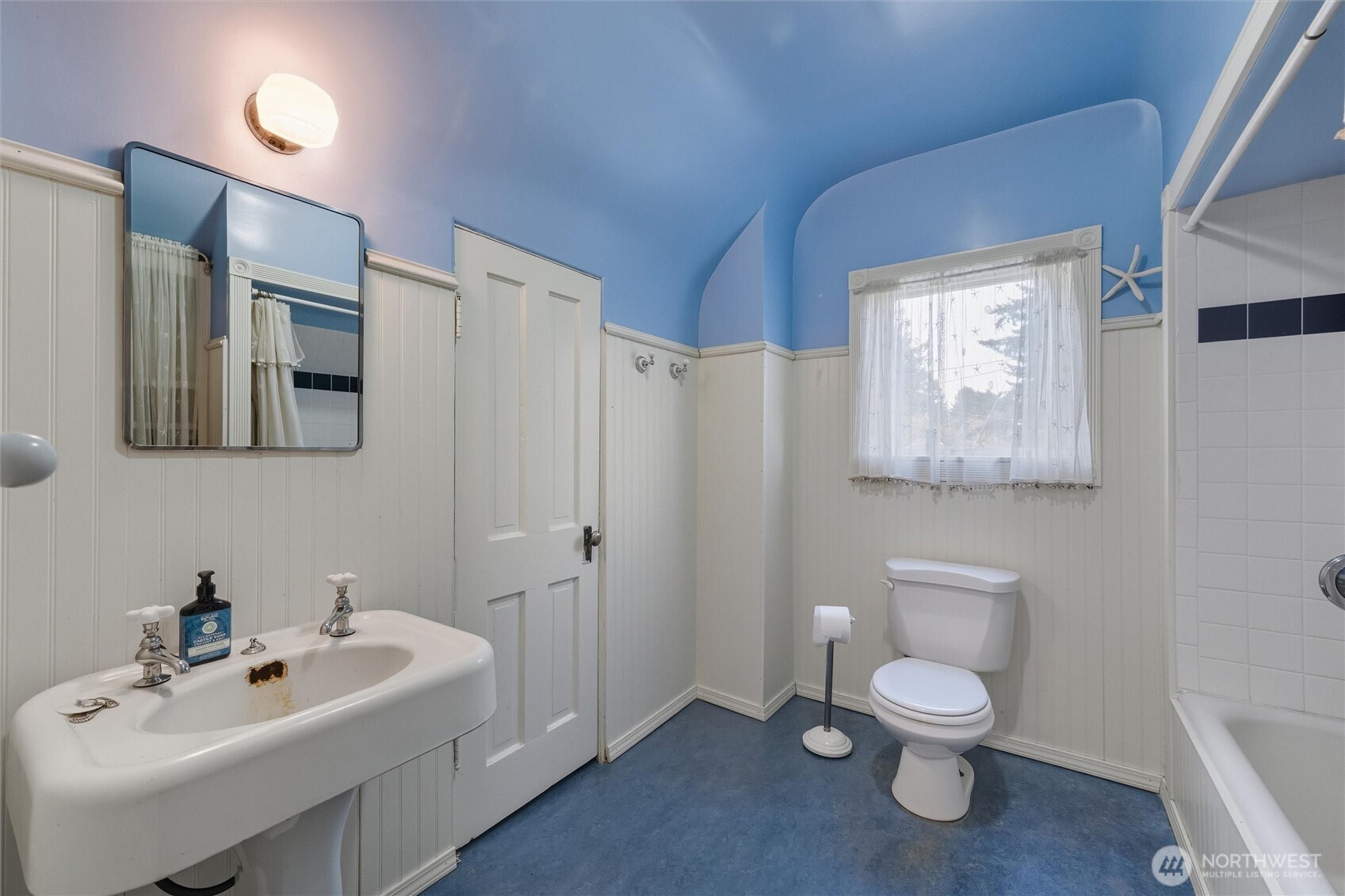 1131 16th Street Bellingham, WA 98225 - Photo 31 of 40 a white toilet sitting next to a bathroom sink