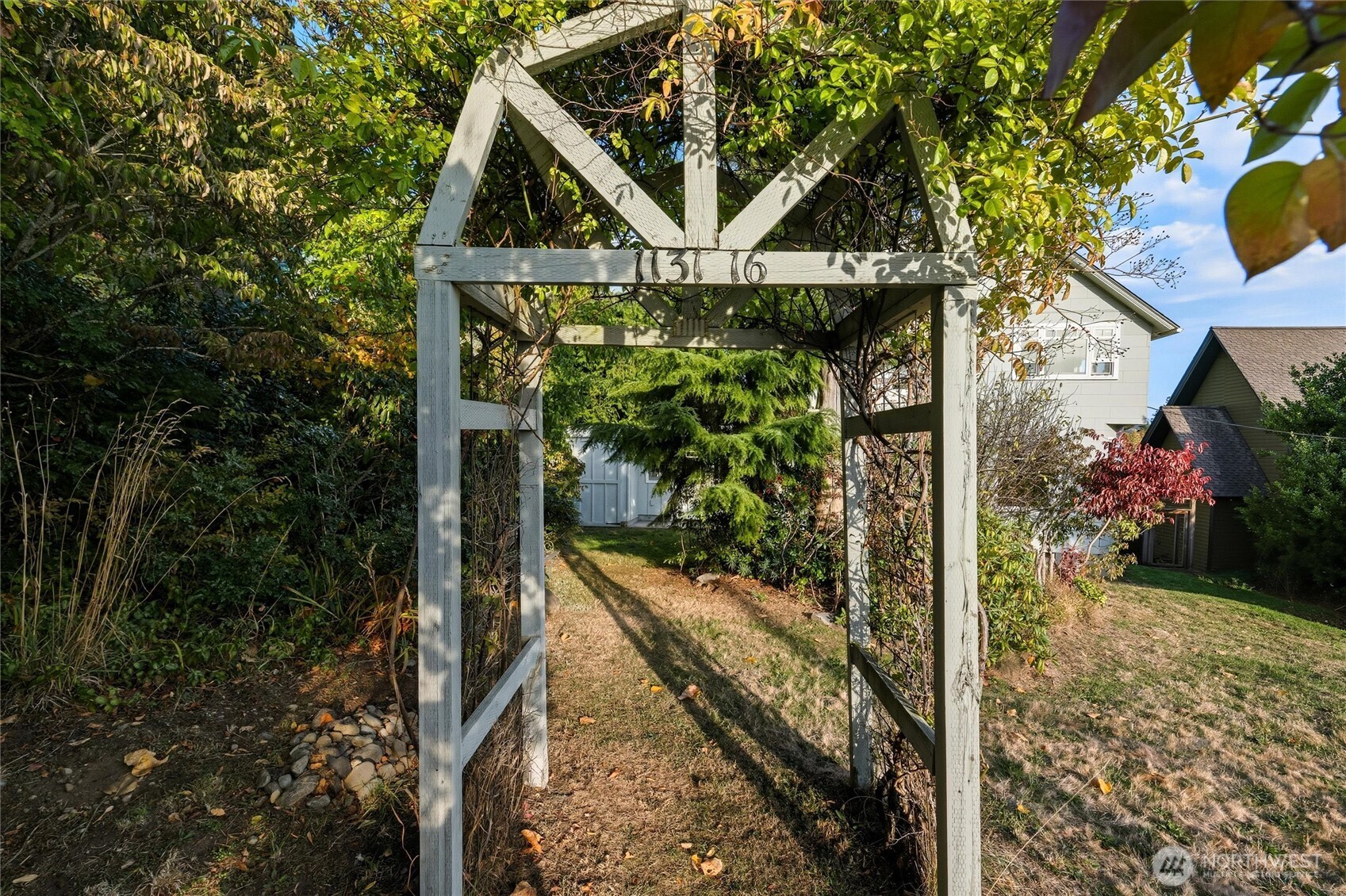 1131 16th Street Bellingham, WA 98225 - Photo 37 of 40 a aerial view of a house with a yard and large trees