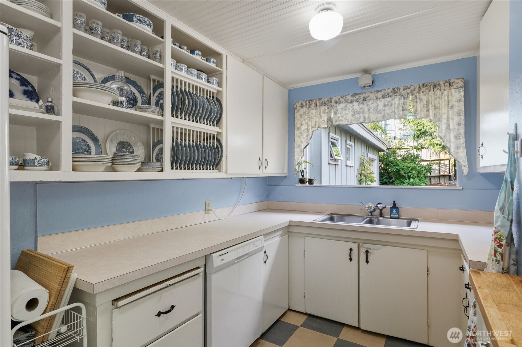 1131 16th Street Bellingham, WA 98225 - Photo 9 of 40 a kitchen with a sink cabinets and a window