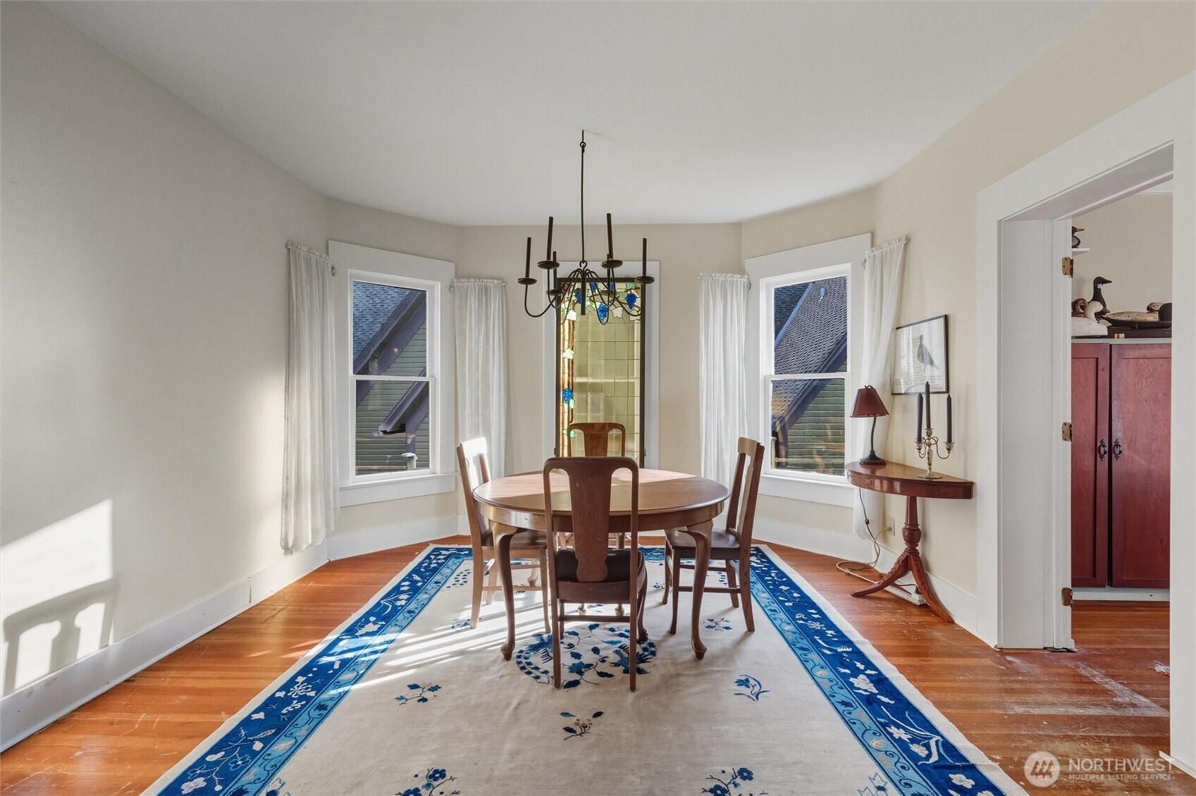 1131 16th Street Bellingham, WA 98225 - Photo 10 of 40 a dining room with wooden floor and a chandelier