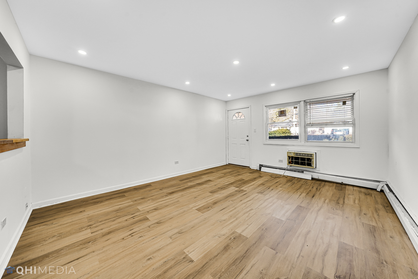 821 Bode Road, Unit 1 Elgin, IL 60120 - Photo 4 of 12 a view of empty room with wooden floor and fan
