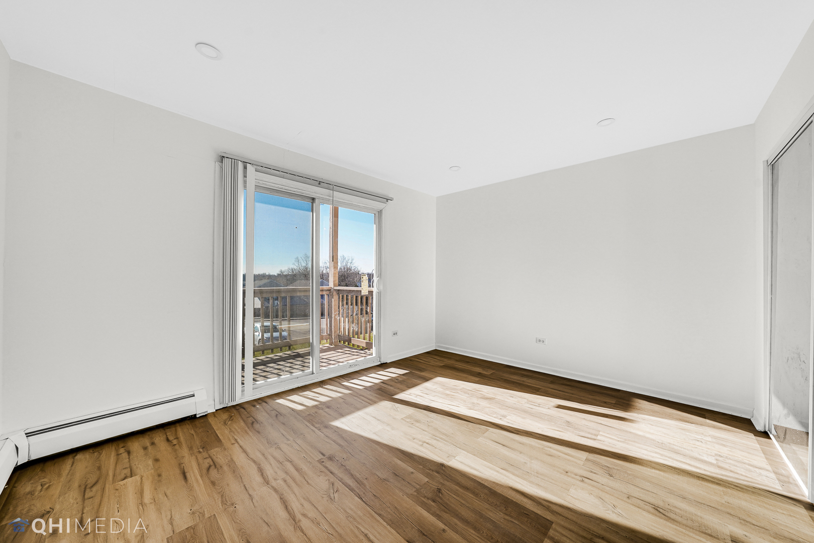 821 Bode Road, Unit 1 Elgin, IL 60120 - Photo 7 of 12 an empty room with wooden floor and windows