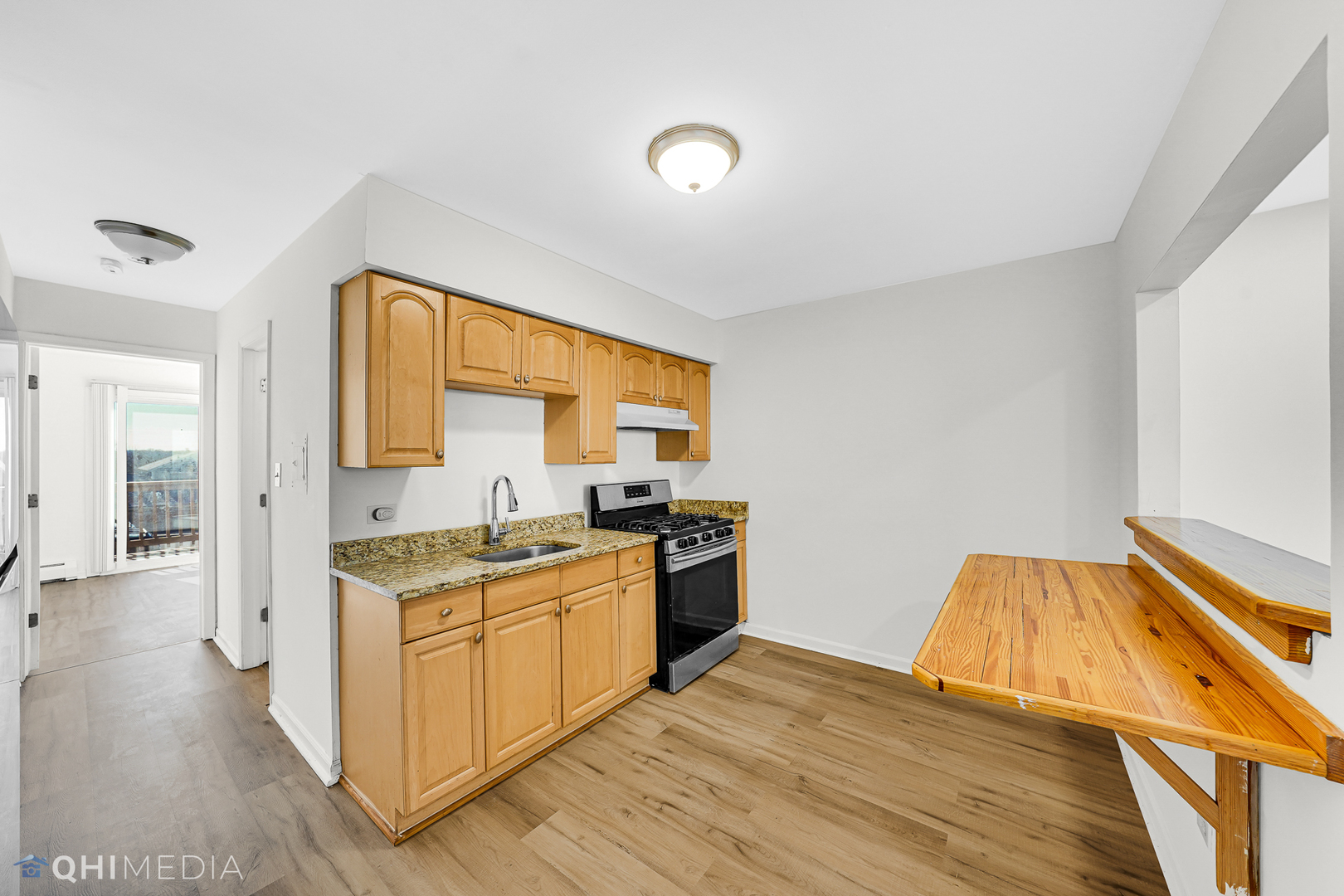 821 Bode Road, Unit 1 Elgin, IL 60120 - Photo 8 of 12 a kitchen with a stove a sink and a refrigerator