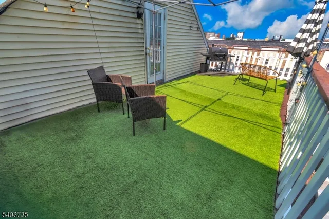 a backyard of a house with table and chairs