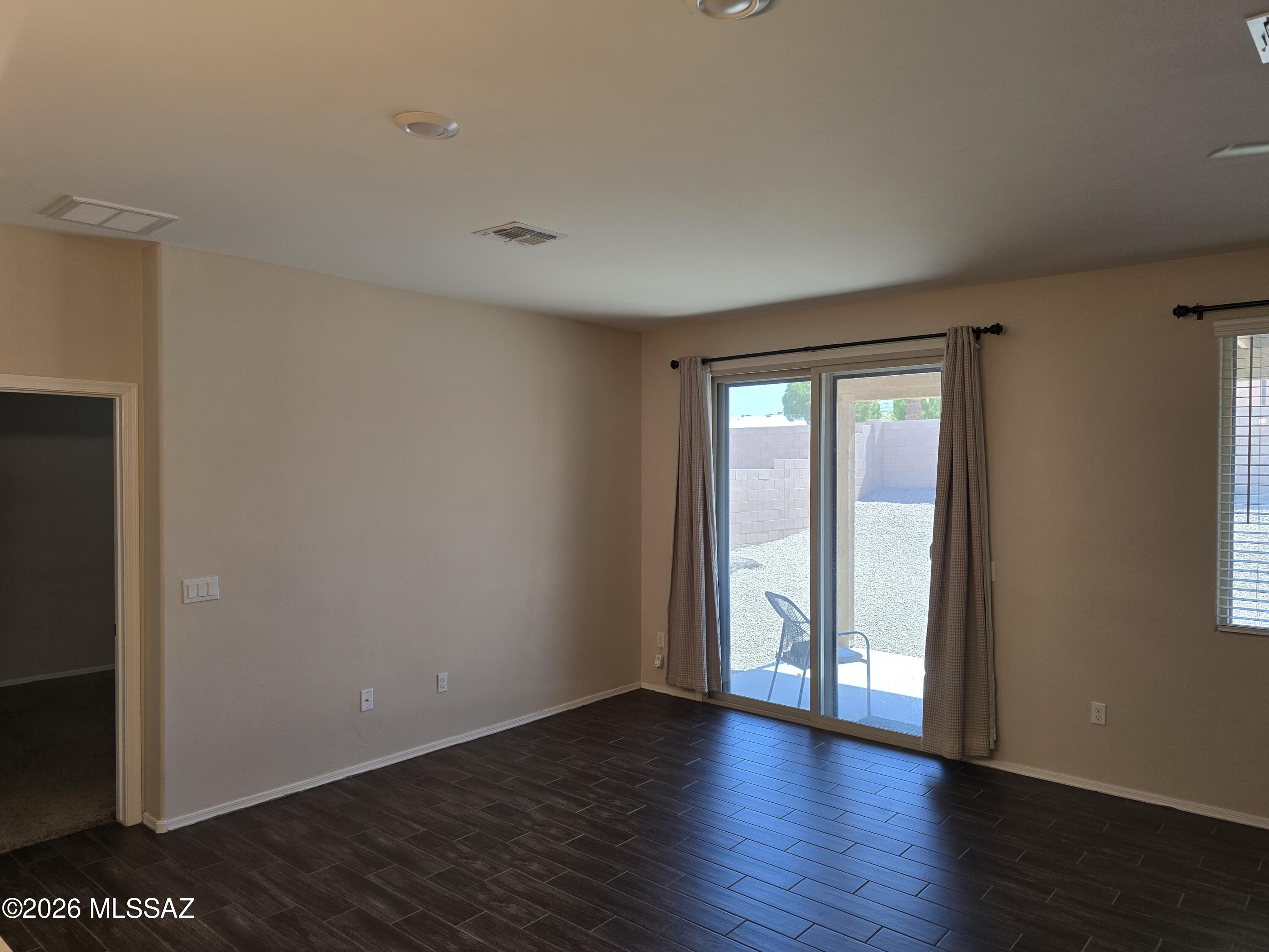 6151 South Antrim Loop Tucson, AZ 85706 - Photo 5 of 13 a view of an empty room with wooden floor and a window
