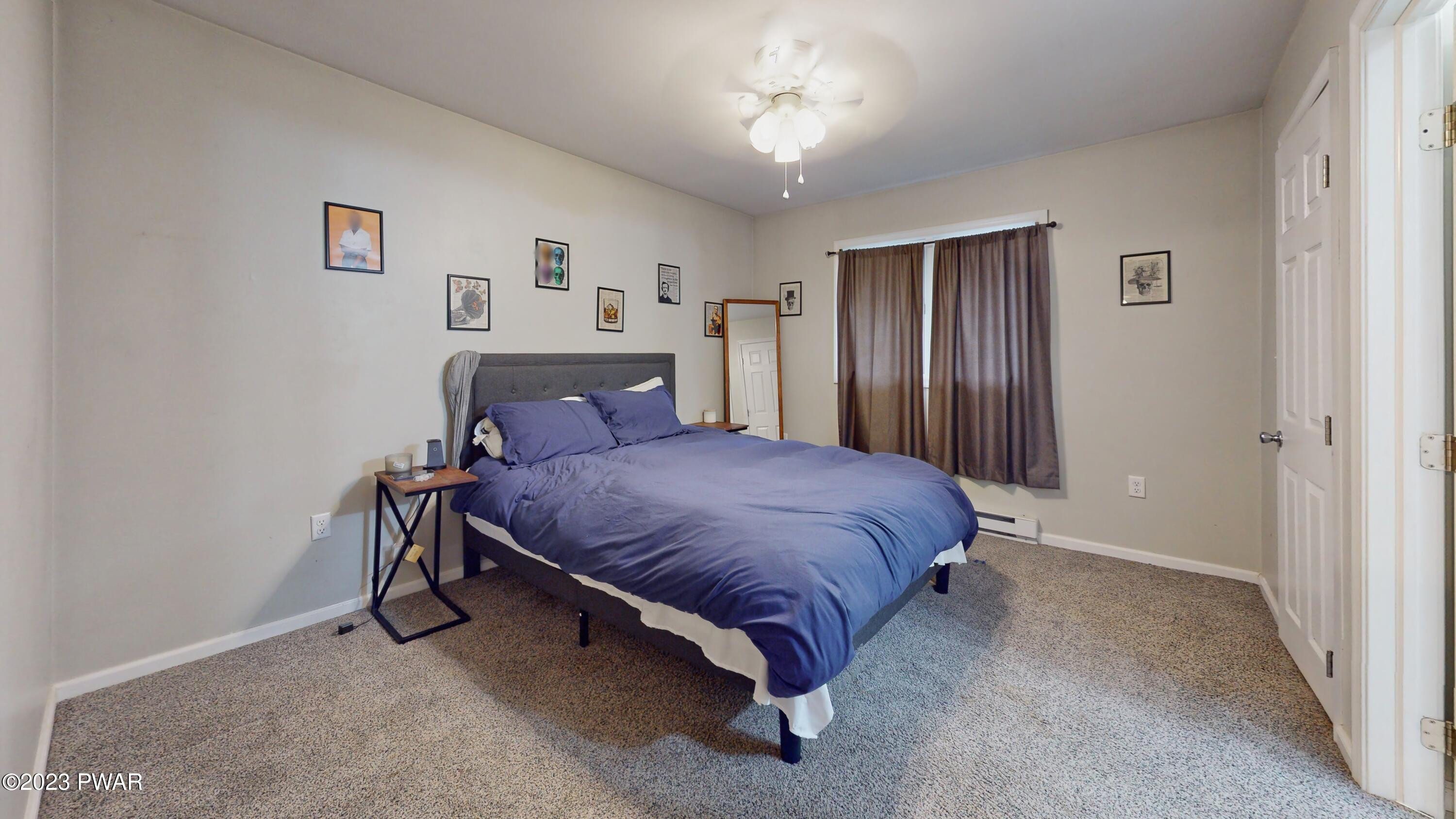149 Walker Lake Road Shohola, PA 18458 - Photo 30 of 51 a bedroom with a bed and a chandelier