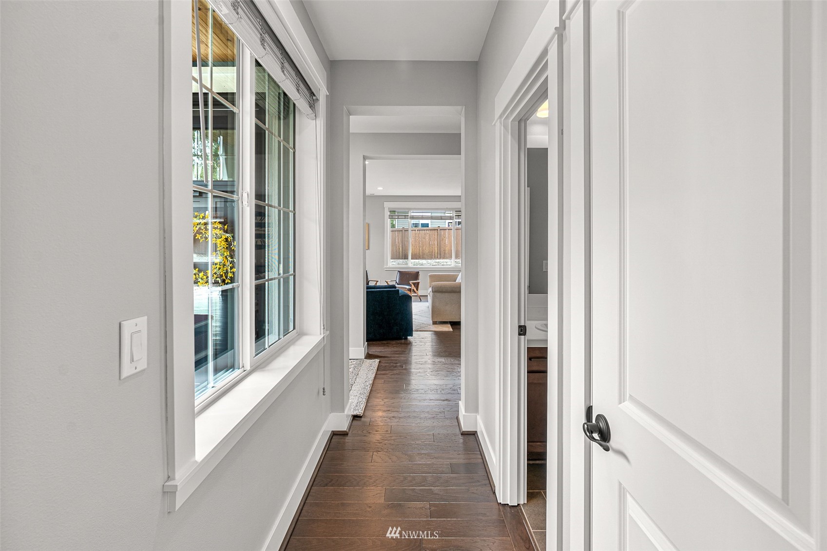 14408 160th Court Southeast Renton, WA 98059 - Photo 15 of 40 a view of a hallway with wooden floor and a living room