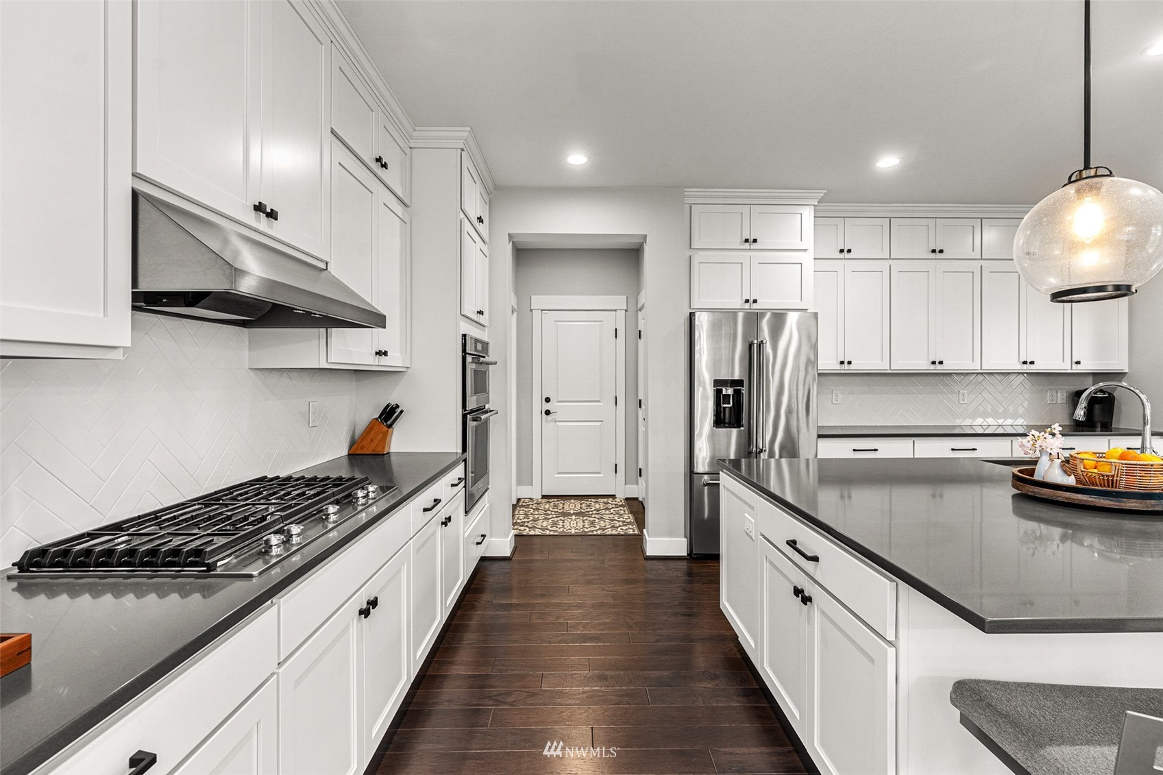 14408 160th Court Southeast Renton, WA 98059 - Photo 10 of 40 a kitchen with stainless steel appliances a sink a stove and a wooden floors