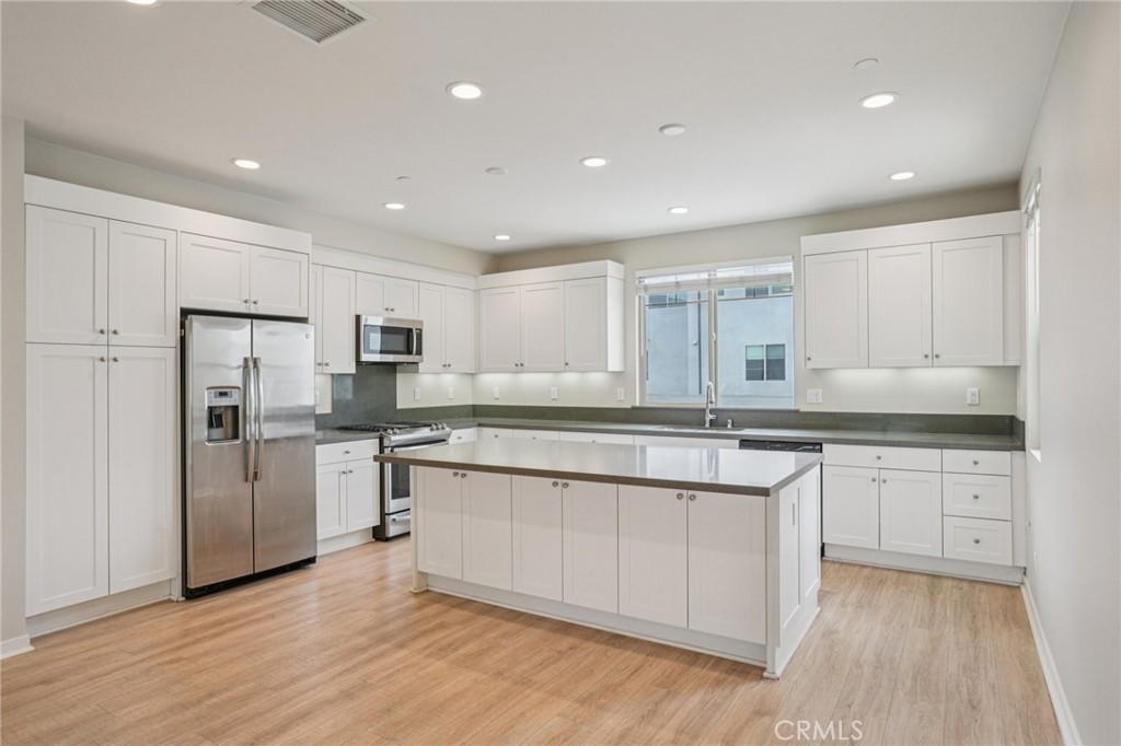 143 Frame Irvine, CA 92618 - Photo 2 of 41 a kitchen with stainless steel appliances granite countertop a stove a sink and a refrigerator