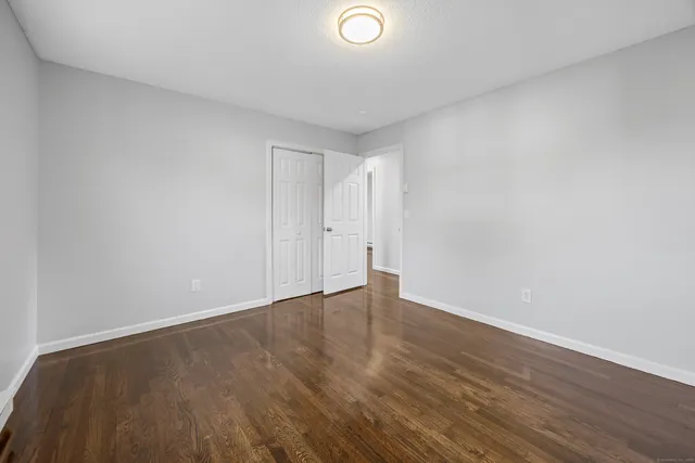 a view of an empty room and wooden floor