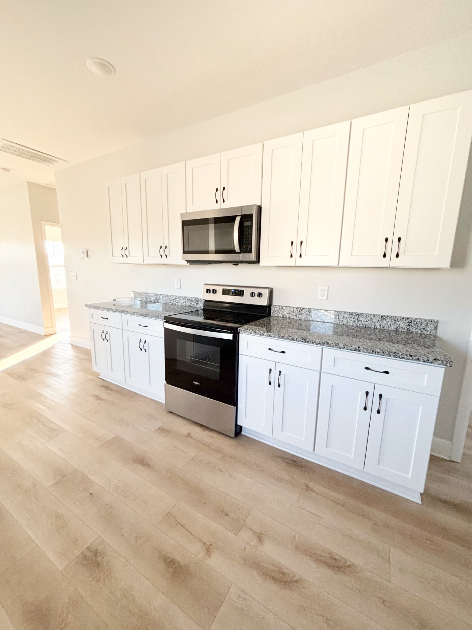 140 Eno Road Dickson, TN 37055 - Photo 2 of 11 a kitchen with granite countertop white cabinets and stainless steel appliances