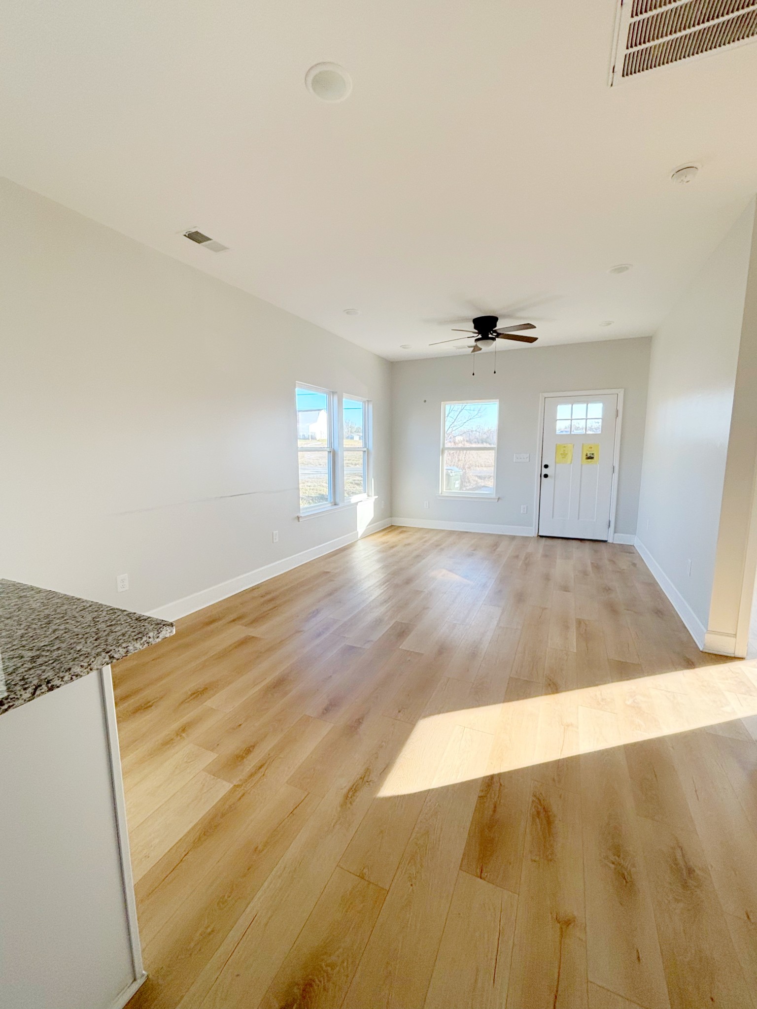 140 Eno Road Dickson, TN 37055 - Photo 4 of 11 an empty room with wooden floor and windows