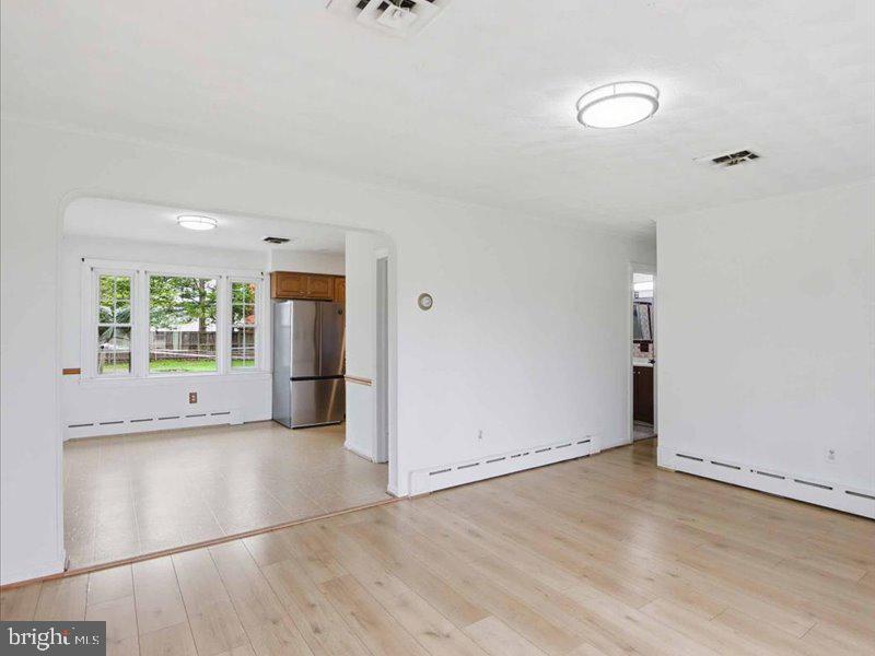 6404 Inwood Drive Springfield, VA 22150 - Photo 11 of 41 an empty room with wooden floor and windows