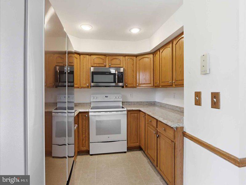 6404 Inwood Drive Springfield, VA 22150 - Photo 24 of 41 a kitchen with stainless steel appliances granite countertop a refrigerator and a stove top oven