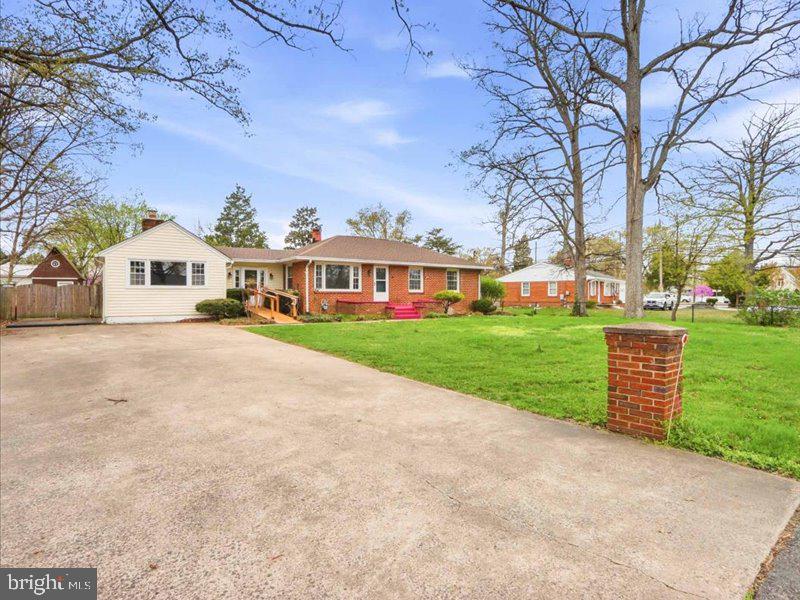 6404 Inwood Drive Springfield, VA 22150 - Photo 3 of 41 a view of a white house with a big yard and large trees