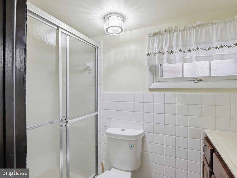 6404 Inwood Drive Springfield, VA 22150 - Photo 32 of 41 a bathroom with a granite countertop sink a toilet and mirror