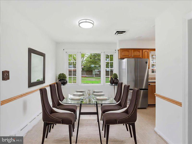 6404 Inwood Drive Springfield, VA 22150 - Photo 7 of 41 a view of a dining room with furniture and a window