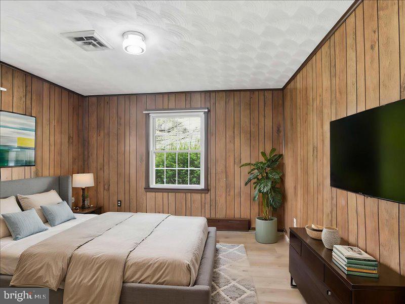 6404 Inwood Drive Springfield, VA 22150 - Photo 10 of 41 a bedroom with a bed and a flat screen tv