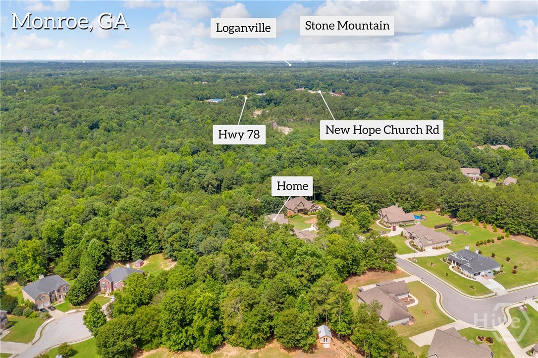2476 St Martin Way Monroe, GA 30656 - Photo 75 of 75 An aerial perspective showcasing the property's setting within a wooded landscape