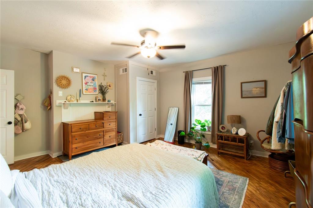 702 Radford Street Monroe, GA 30655 - Photo 15 of 49 a bedroom with a bed and a chandelier