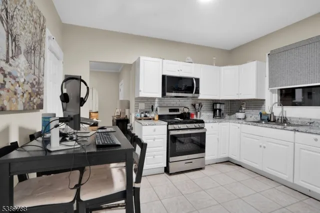 a kitchen with sink a microwave and stove