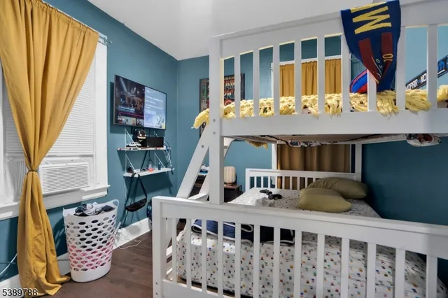 a bedroom with furniture and a large window