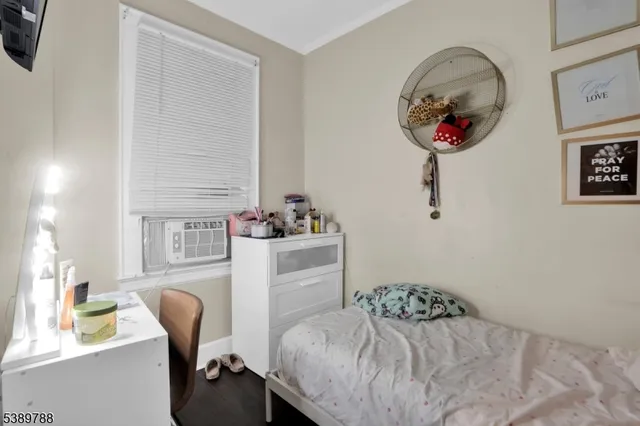 a bedroom with a bed and a chair in it