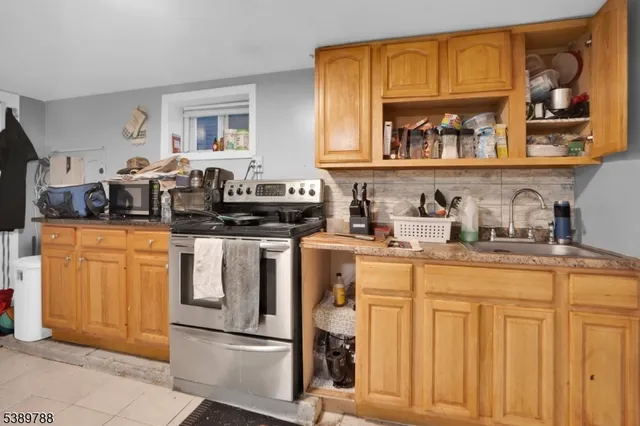 a kitchen with white cabinets and sink