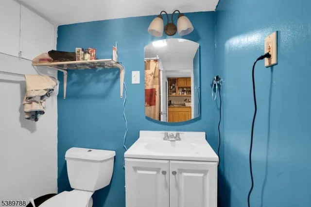a bathroom with a toilet sink and mirror